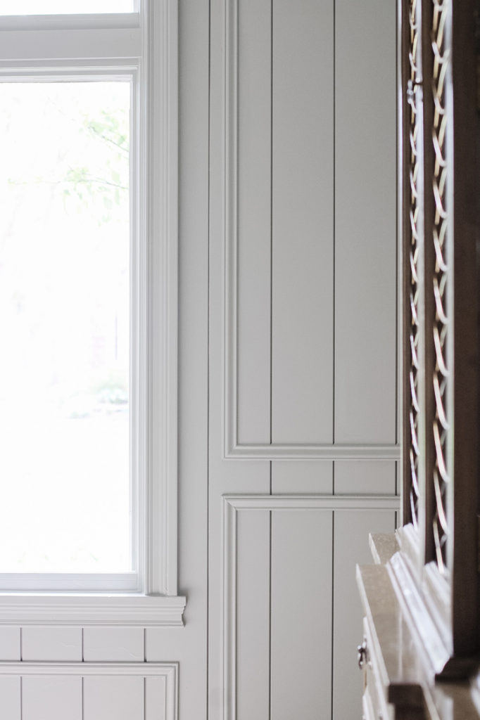 Vertical panel molding with picture frame trim molding on top combined in this DIY wall molding. Painted Farrow & Ball 