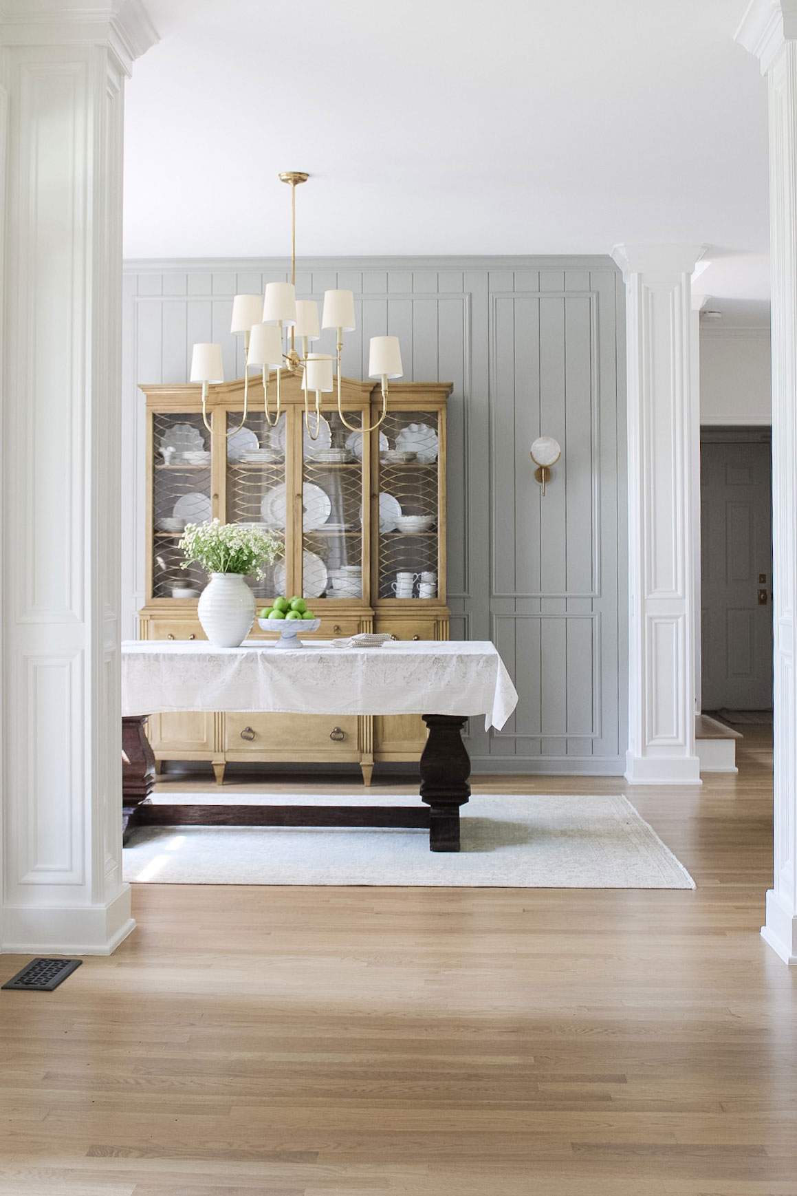 dining room with layered vertical shiplap and picture frame moulding 