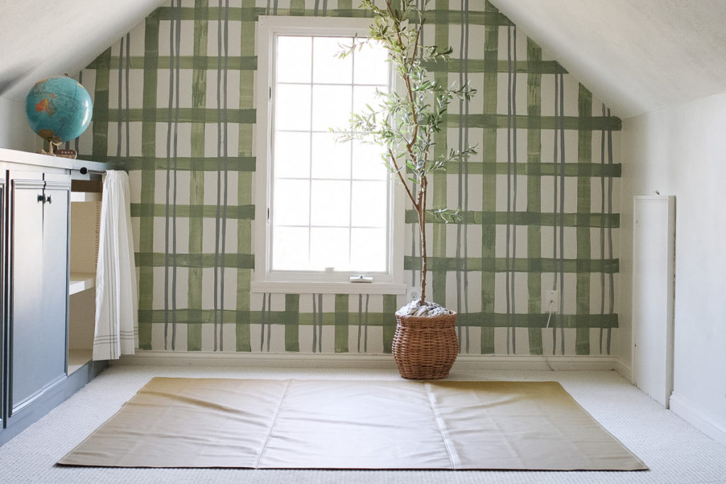 A green watercolor plaid painted mural on a pitched roof wall