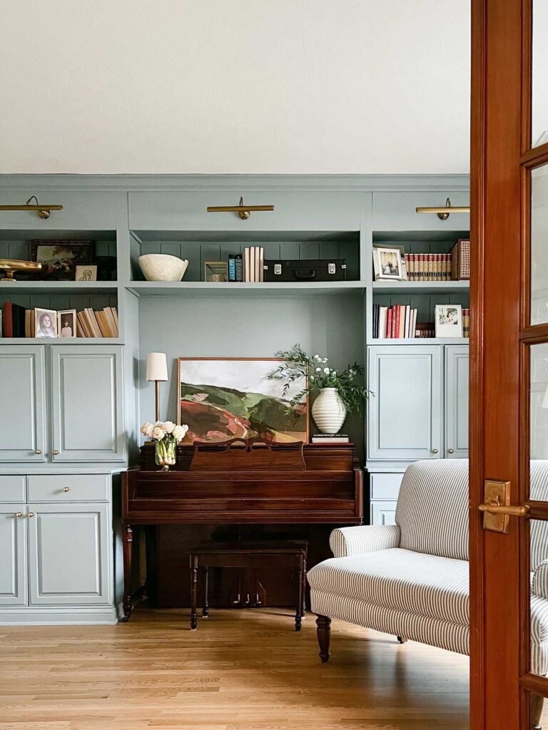piano surrounded by cabinets painted in Sherwin William Debonair, blue