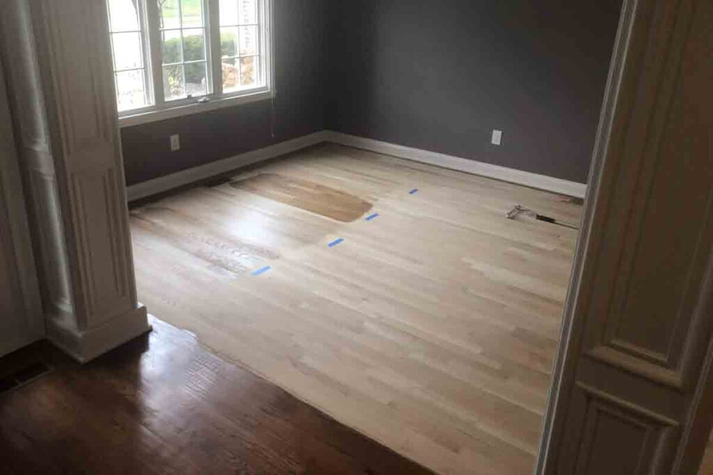 Testing stain samples on unfinished hardwood flooring