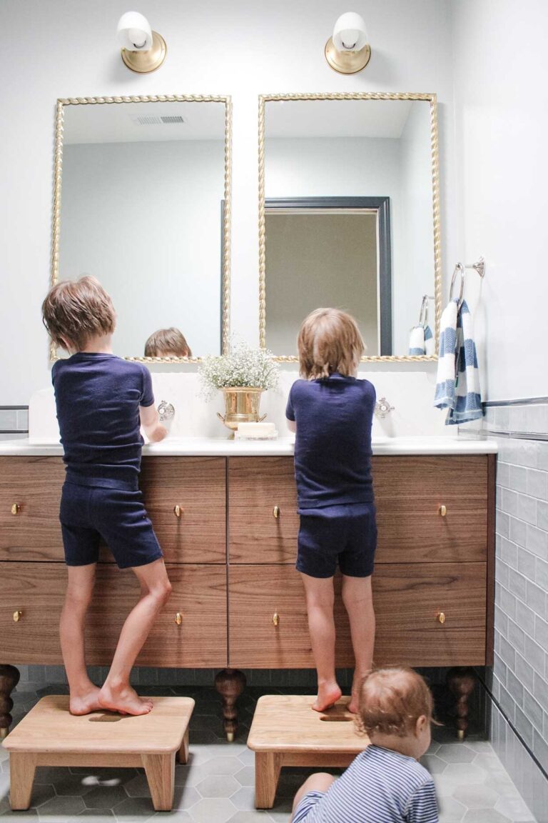 Walnut vanity made from an Ikea godmorgon hack. Kids are using the sink to wash their hands