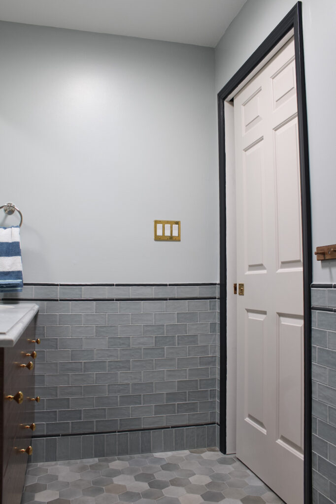 Pocket door tubular hardware in unlacquered brass on a bathroom pocket door. 