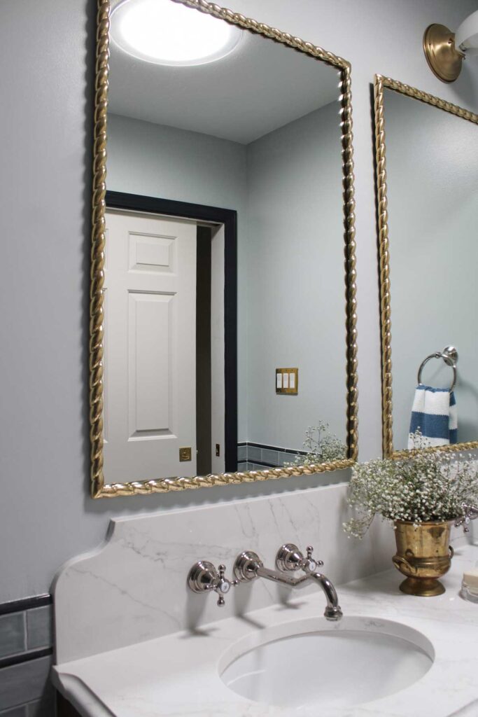 A windowless bathroom with a sun tunnel reflecting in the mirror.