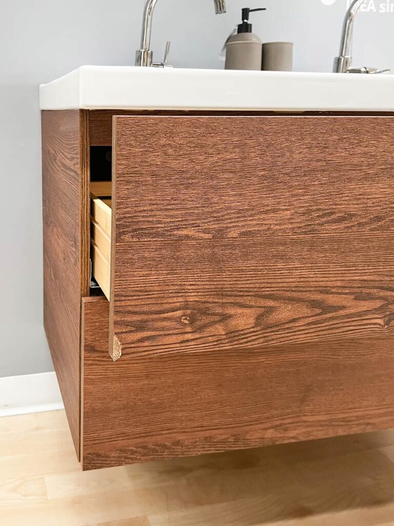 an in store display of the ikea godmorgon vanity in the walnut effect showing damage on the drawer