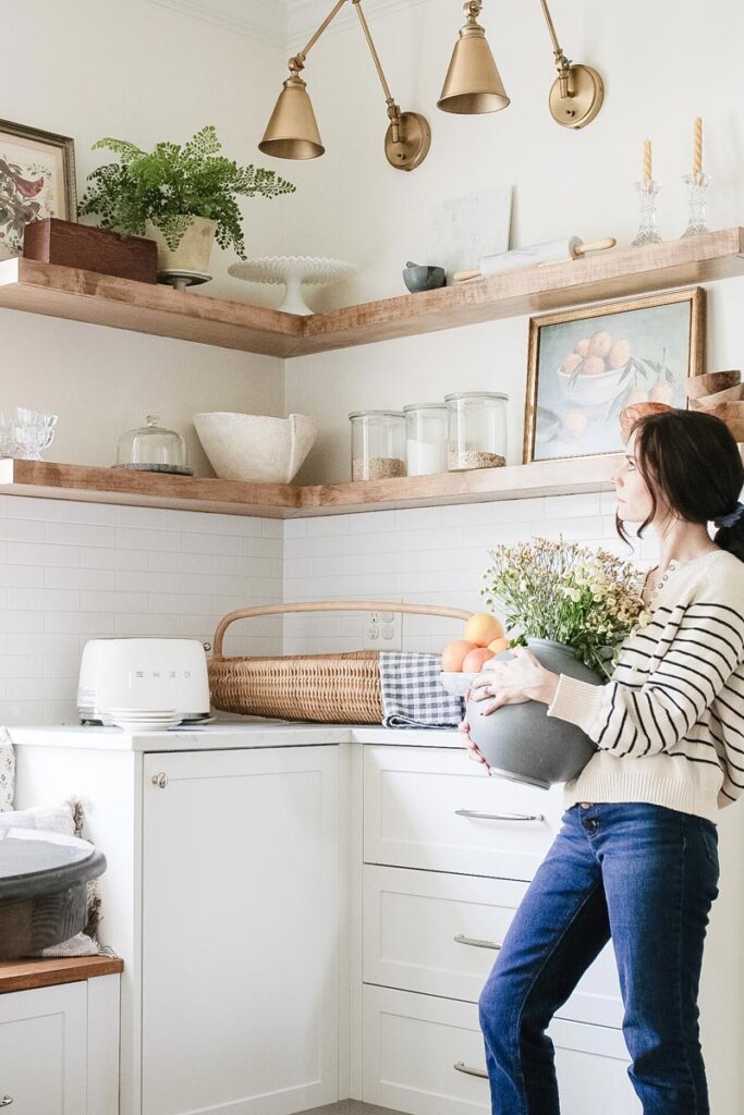 maple kitchen shelving styled above white kitchen cabinets